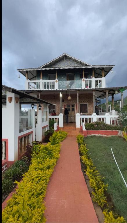 a large house with a pathway leading to it at Sandiago Villa 2 Bhk House - Only Bachelors Adults in Ooty