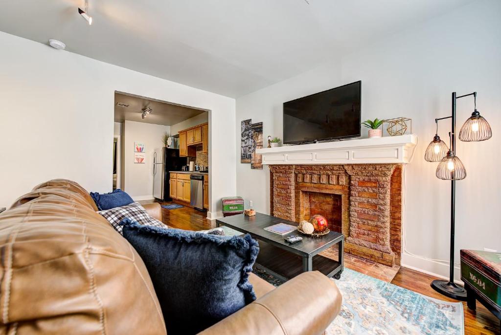 a living room with a couch and a fireplace at Putnam Pad II - City card 4 local biz discount in Oklahoma City