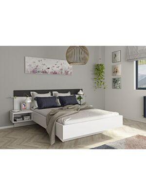 een slaapkamer met een bed met een wit bedframe bij Only for family or married couple (furnished flat) in El Jadida