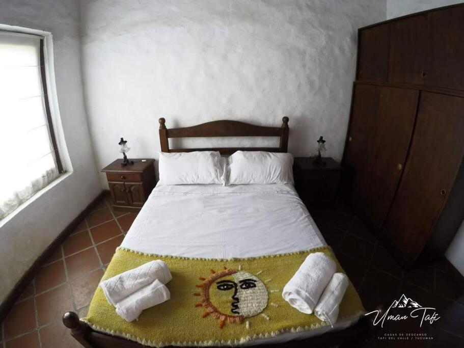 a bedroom with a bed with a face painted on it at La Escondida in Tafí del Valle