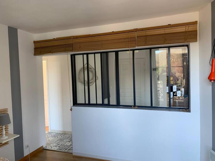 a living room with a large window on the wall at La cabine d&#39;Amélie in Veules-les-Roses