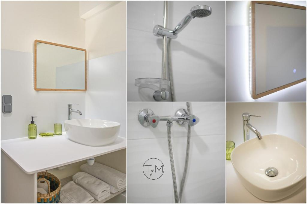 a white bathroom with a sink and a mirror at Foyal City Center in Fort-de-France