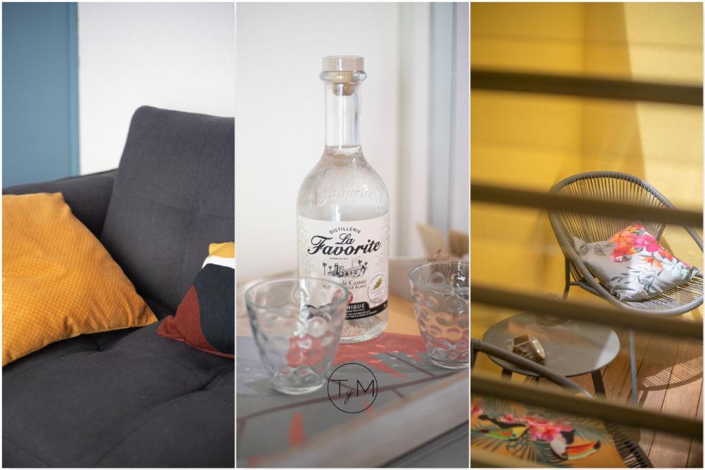 a bottle of alcohol sitting on a table next to glasses at Foyal City Center in Fort-de-France