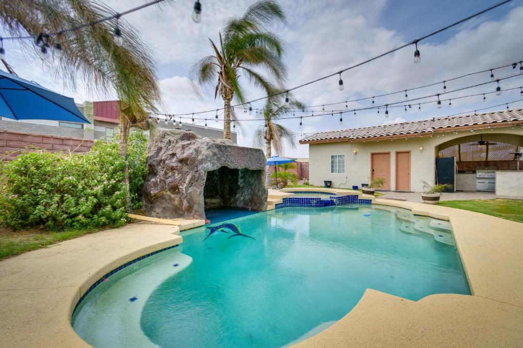 a swimming pool with a waterfall in a house at Luxe Yuma Home with Private Pool! in Yuma