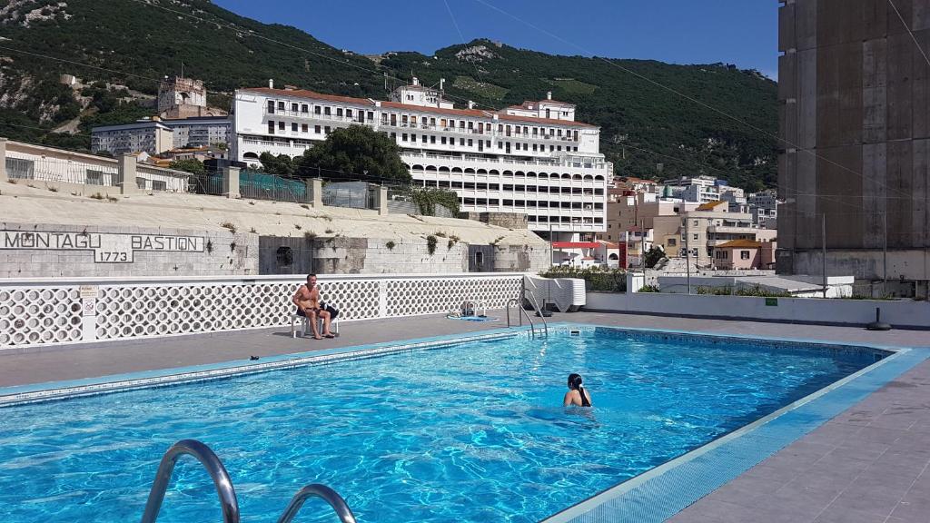 a person in a swimming pool in a city at Gibraltar Gem in Gibraltar