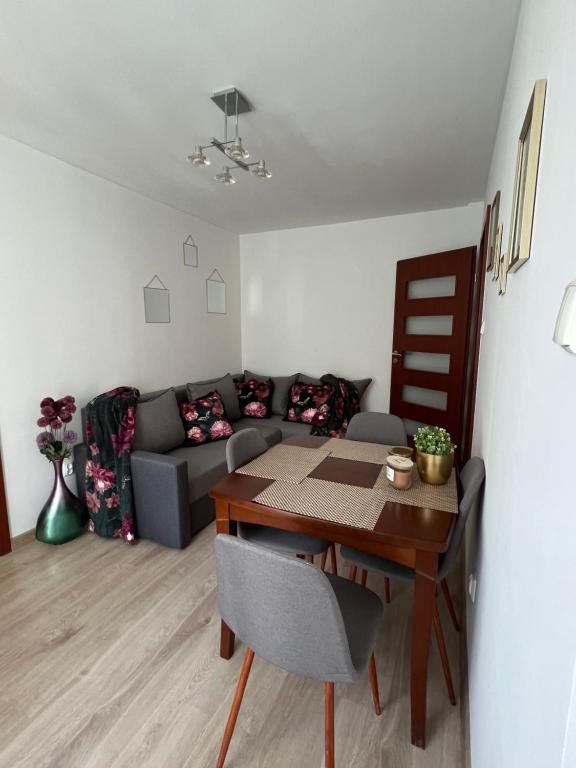 a living room with a table and a couch at Zgierz Parzęczewska District in Zgierz