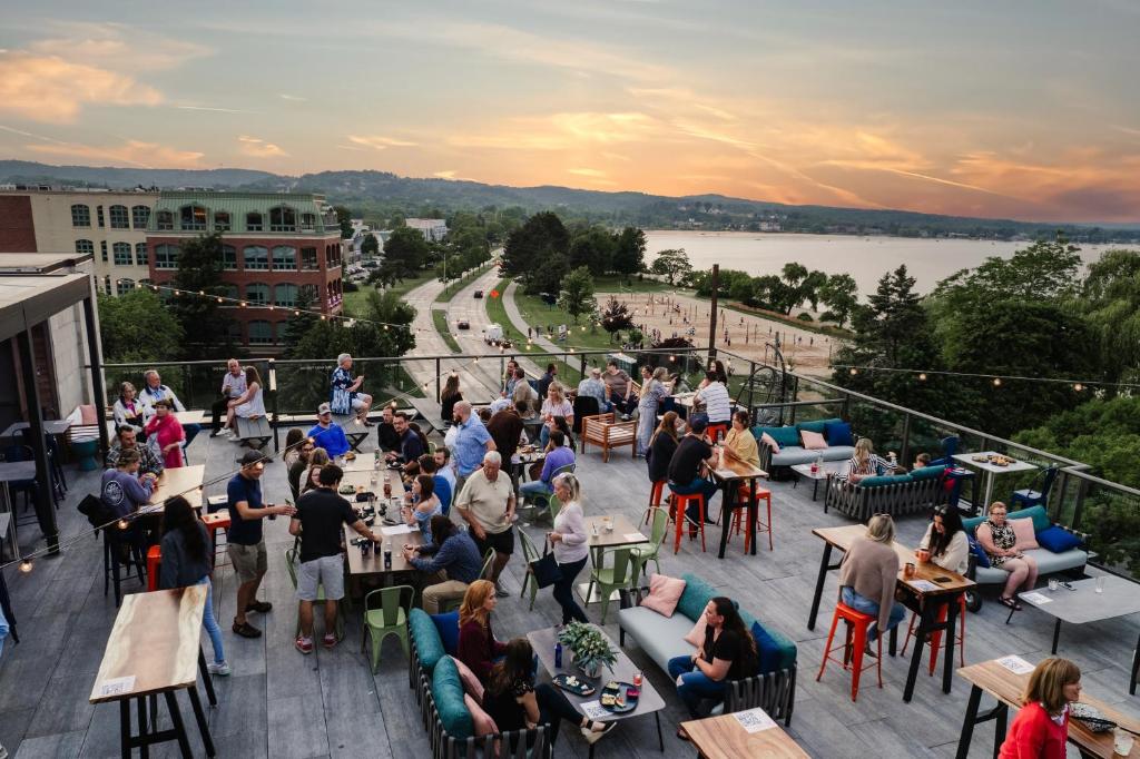 a crowd of people sitting at tables on a balcony at Hotel Indigo Traverse City, an IHG Hotel in Traverse City