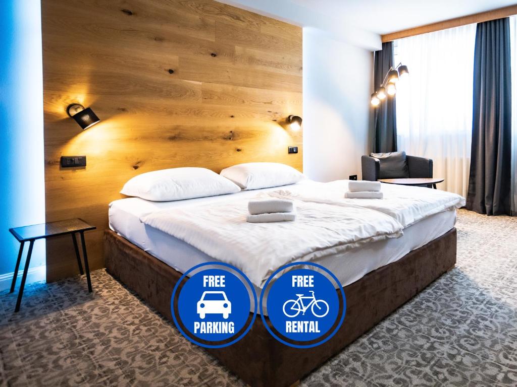a hotel room with a bed with free parking signs on it at Ljubljana Resort Hotel & Camping in Ljubljana