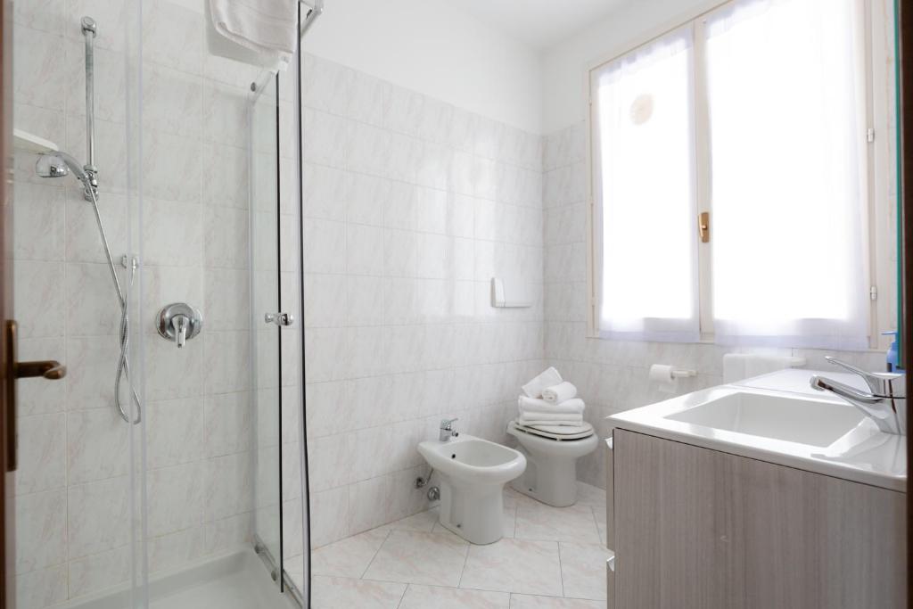 a bathroom with a shower and a toilet and a sink at Carola's place - by Relais Di Giada in Como