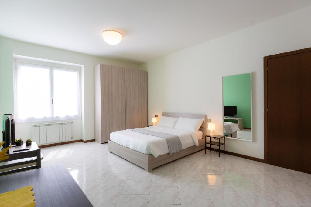 a bedroom with a bed and a large window at Carola's place - by Relais Di Giada in Como
