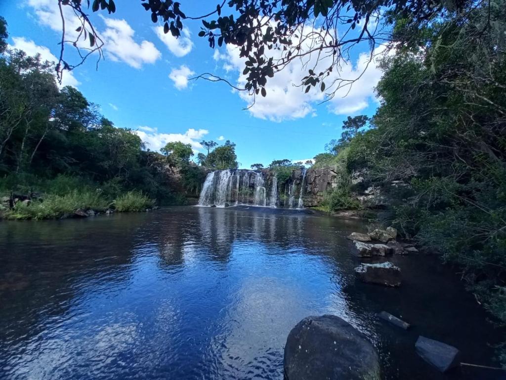 a waterfall in the middle of a river at Pousada Recanto da Cascata - Cabana Platano in São Joaquim