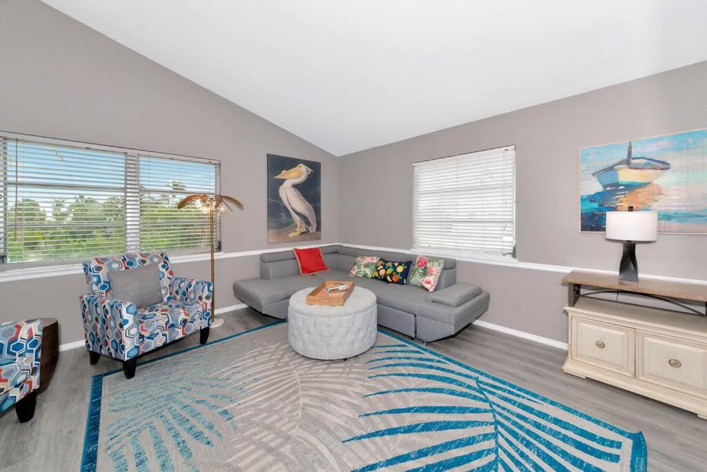 a living room with a couch and chairs and a table at Walk to the beach - Island Villa in Siesta Key