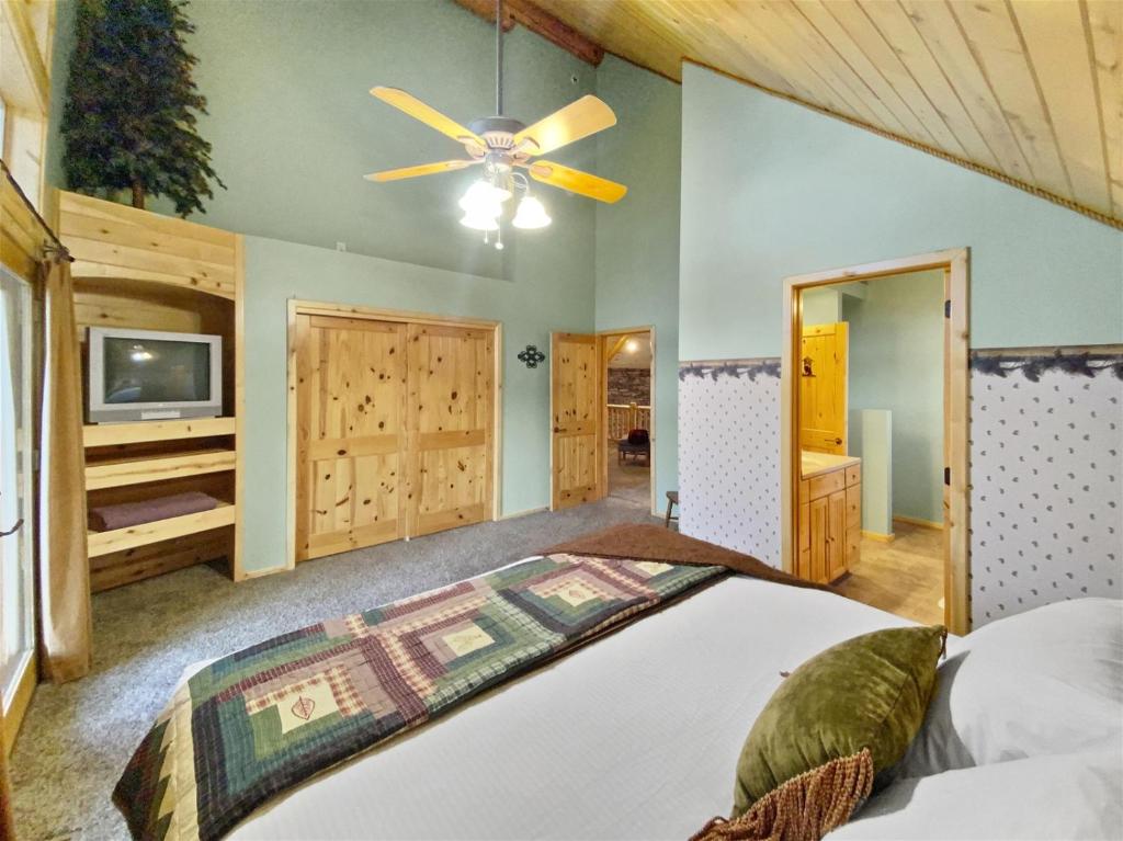 The Bison At Panguitch Lake في بانغويتش: غرفة نوم بسرير ومروحة سقف
