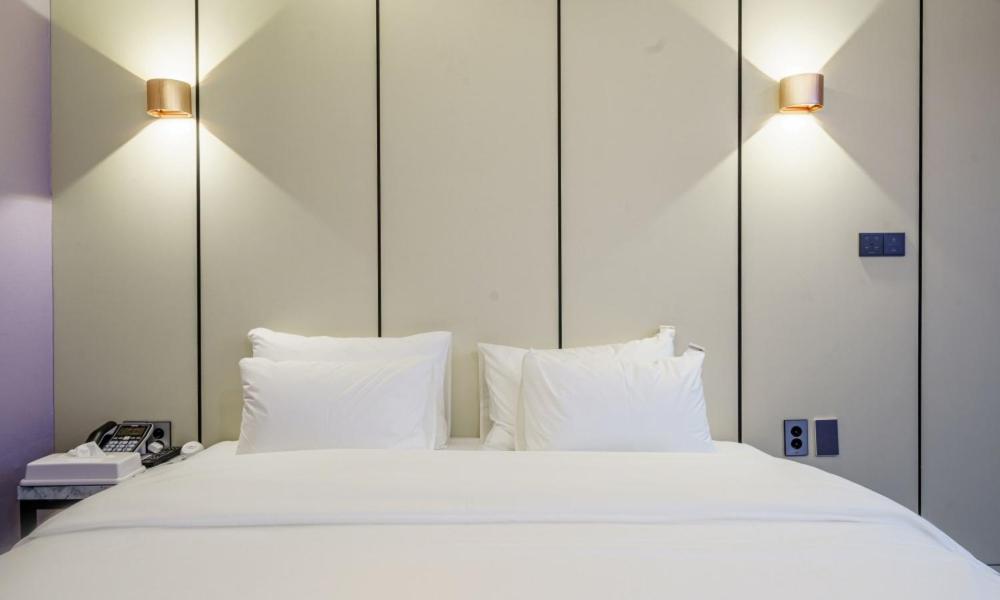 Postel nebo postele na pokoji v ubytování G7 Hotel