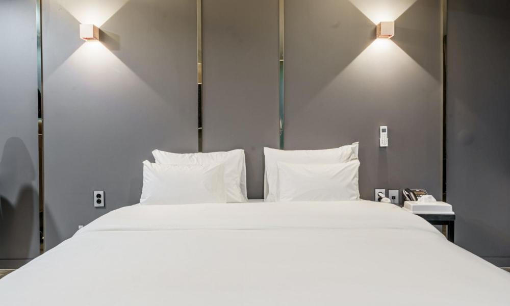 Postel nebo postele na pokoji v ubytování G7 Hotel