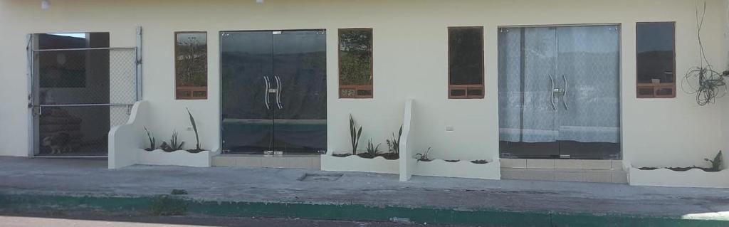 a row of glass doors on the side of a building at EDIFICIO CUPIL in Puerto Baquerizo Moreno
