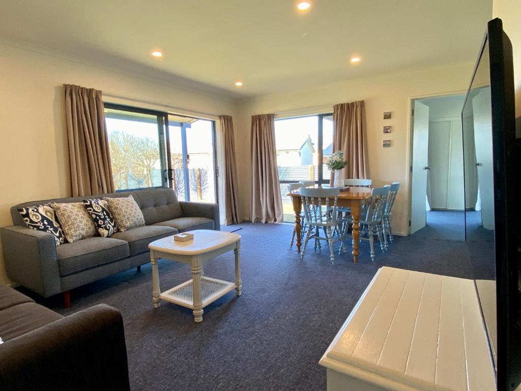 a living room with a couch and a table at Apartment Style Holiday Home in Twizel