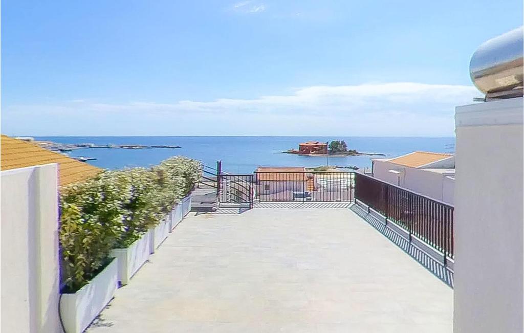 a view of the ocean from the balcony of a building at 1 Bedroom Nice Apartment In Marzamemi in Marzamemi