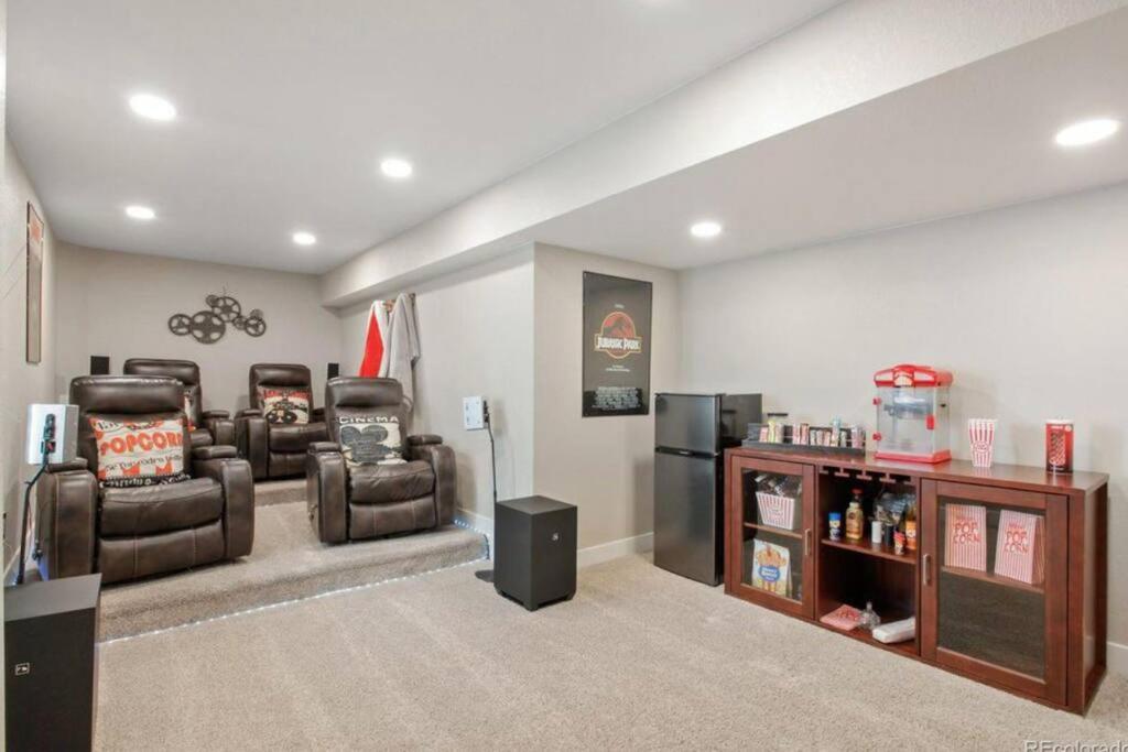 a living room with three chairs and a refrigerator at *Your Colorado Escape* in Commerce City