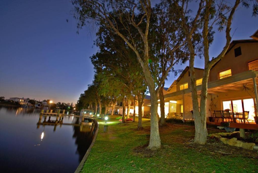 ヌーサヴィルにあるNoosa Entrance Waterfront Resortの夜の川の横の家
