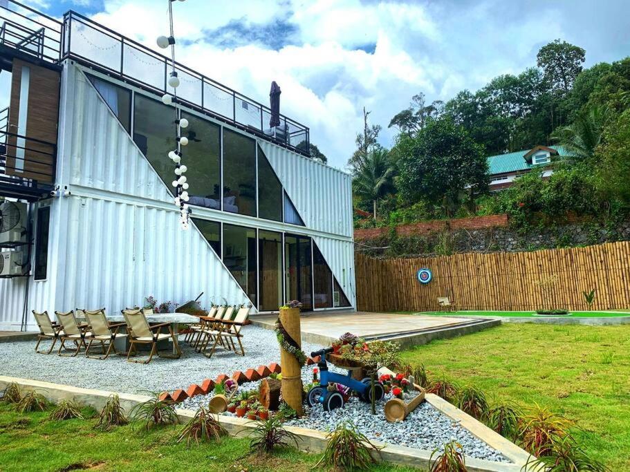 a house with a garden with a train in front of it at The White Box (Genting Highland Foot Area) in Bentong
