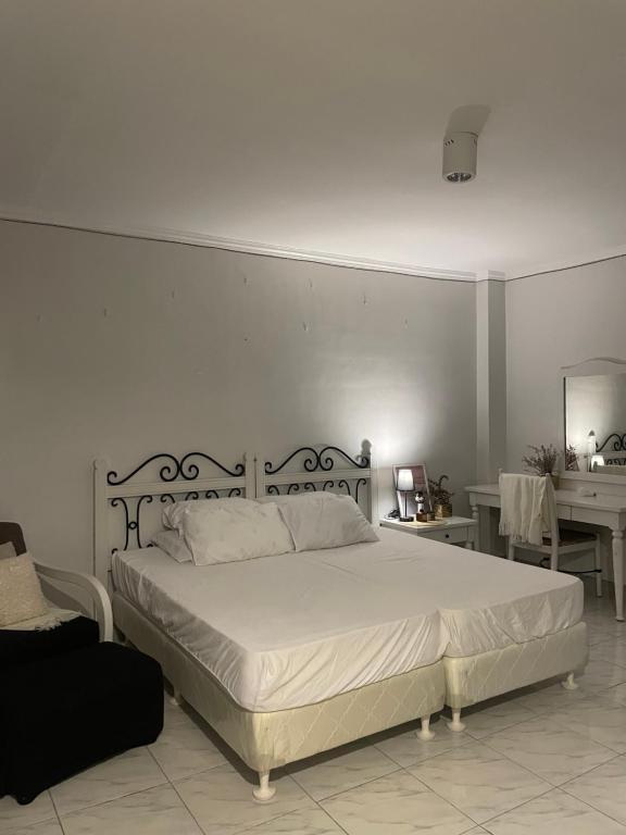 a bedroom with a large bed with a white bedspread at Cozy Condo Unit in SBFZ in Kababae