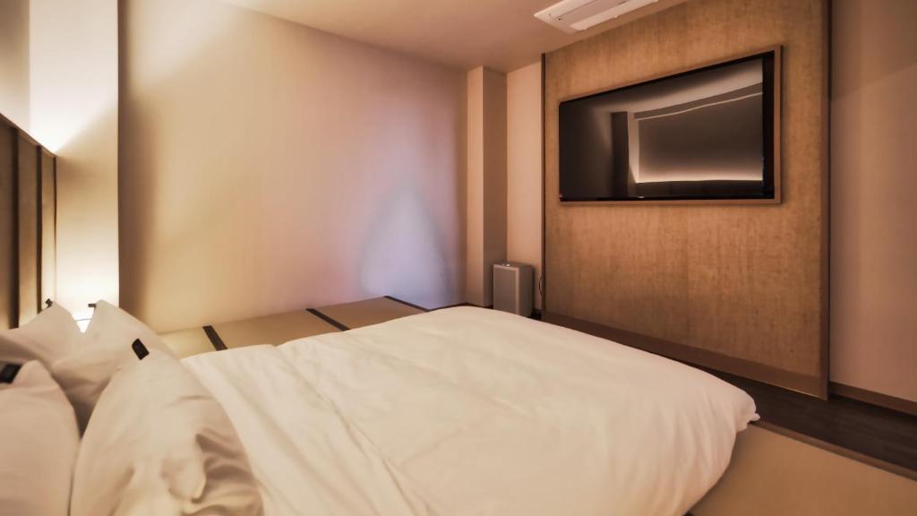 Postel nebo postele na pokoji v ubytování Mandeok Denbasta Ryokan