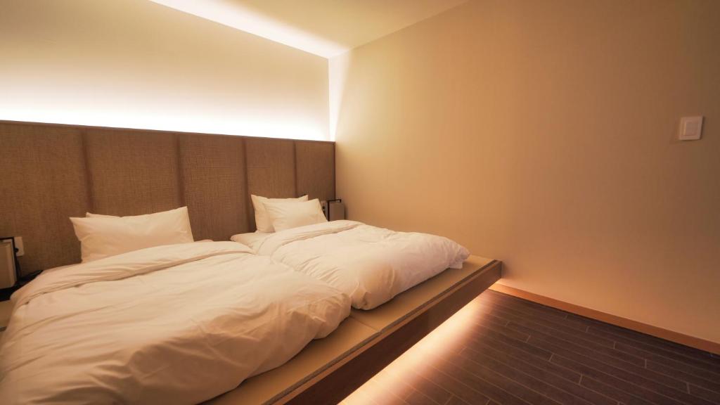 Postel nebo postele na pokoji v ubytování Mandeok Denbasta Ryokan