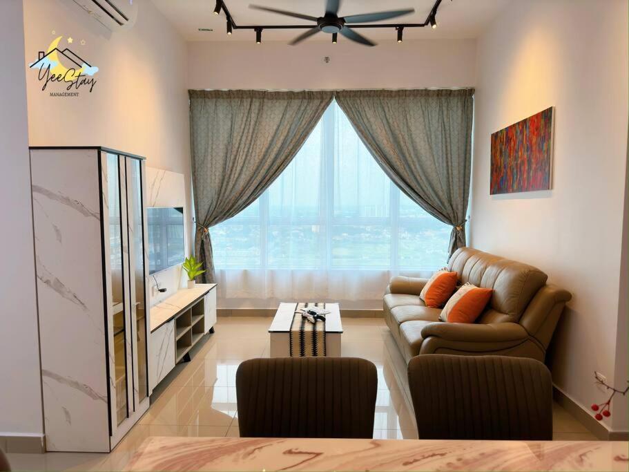 a living room with a couch and a large window at Amber Cove 7pax/VideoGame/5min to Jonker in Melaka