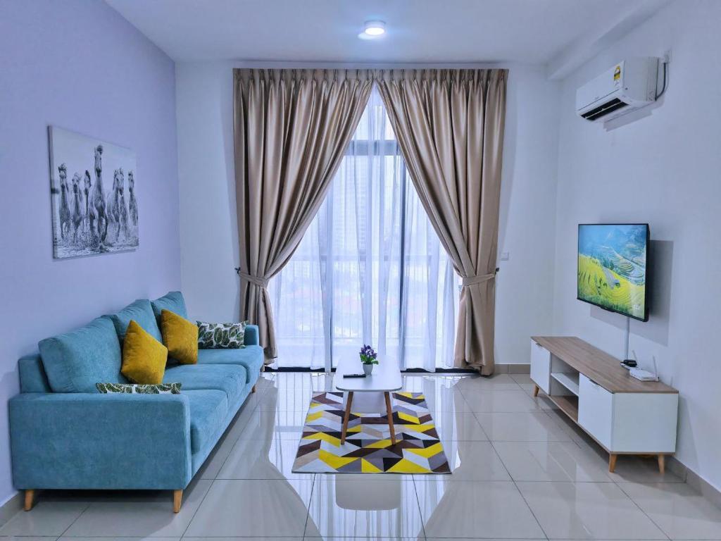 - un salon avec un canapé bleu et une grande fenêtre dans l'établissement Twin Tower Residence JB City by SC Homestay, à Johor Bahru