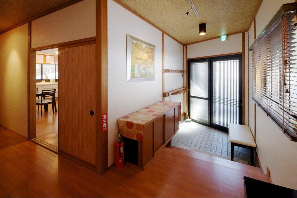 a living room with a table and a dining room at Hakuba Forest House in Hakuba