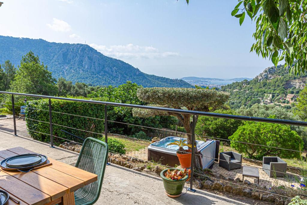 a balcony with a table and chairs and a tub at La Villa Jausserane in Toulon