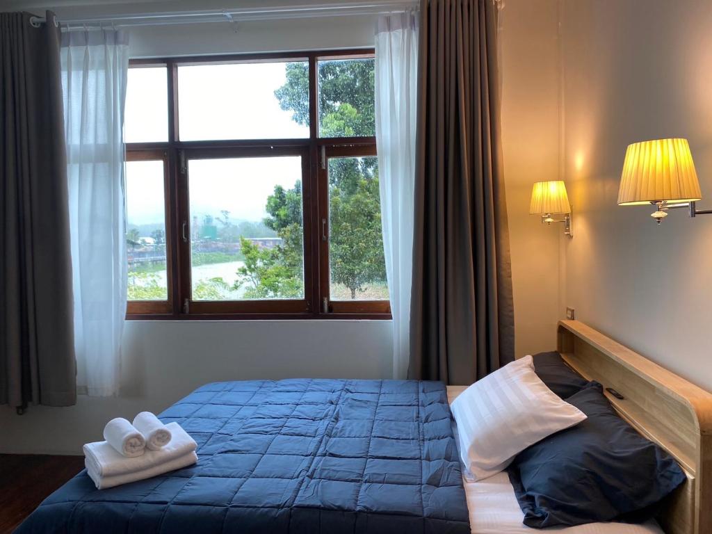 ein Schlafzimmer mit einem Bett mit zwei Handtüchern darauf in der Unterkunft Rivera 105 Vacation Home in Kathun