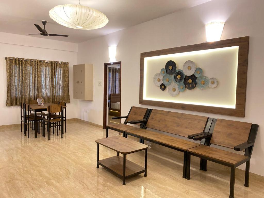 a room with tables and chairs and a painting on the wall at La Tamara Luxury in Puducherry