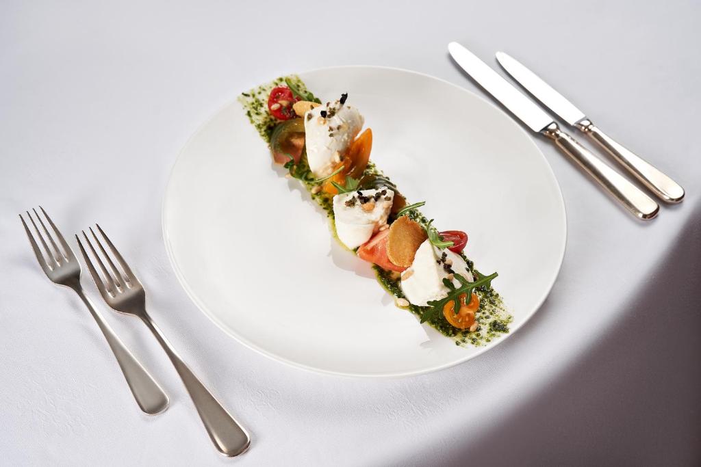 a white plate with food in the shape of a heart at Schlosshotel Ischgl 5-Sterne Superior in Ischgl