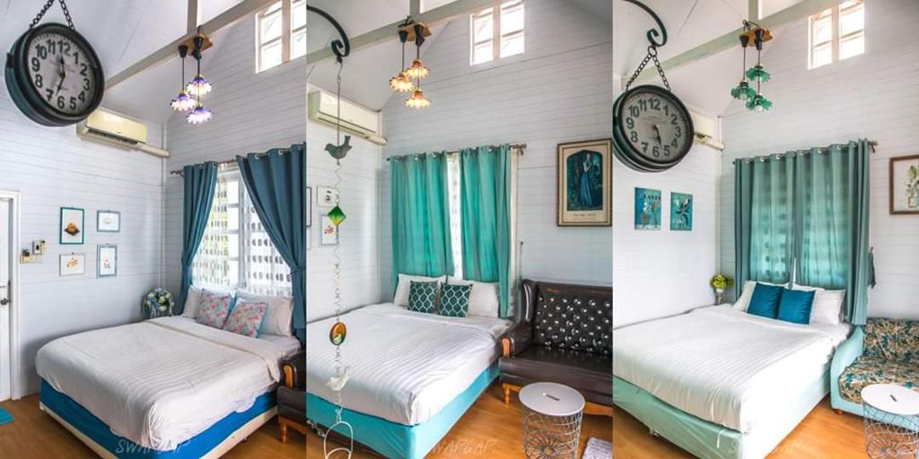 a room with two beds and a clock on the wall at Laemsing Whitehouse Resort in Laem Sing