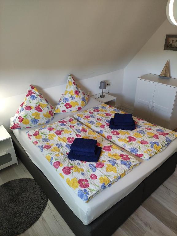 a bed with two pillows and a blanket on it at Ferienwohnung Braun 'Haus Fidi' in Borkum