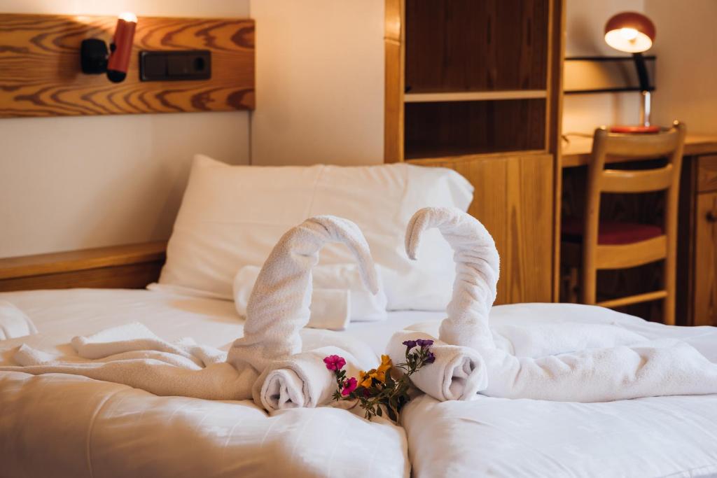 Postel nebo postele na pokoji v ubytování Aparthotel Maso Corto