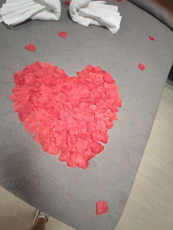 a heart made of pink hearts on a table at Piazza Dante in Taranto