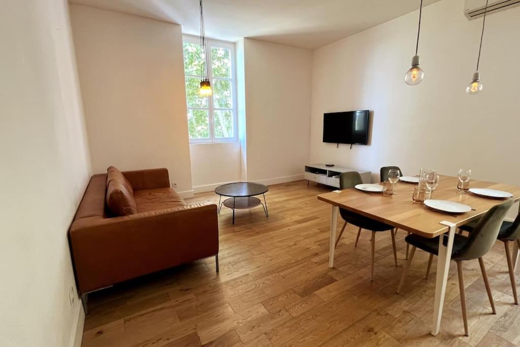 un salon avec une table et un canapé dans l'établissement Gaby - Du cachet pour toute la famille, à Avignon
