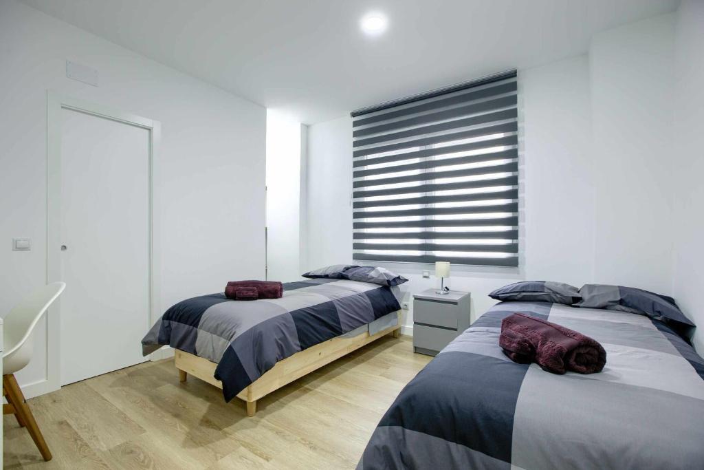 A bed or beds in a room at Casa de Huéspedes 12 Octubre Rooms