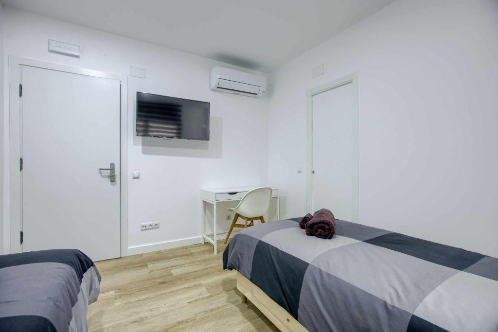 A bed or beds in a room at Casa de Huéspedes 12 Octubre Rooms