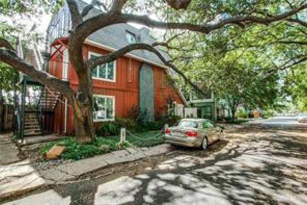 une voiture garée devant une maison rouge dans l'établissement A PRIVATE 3 BD 2 BTH CONDO OAKLAWN TURTLE CREEK Roswell Court, à Dallas