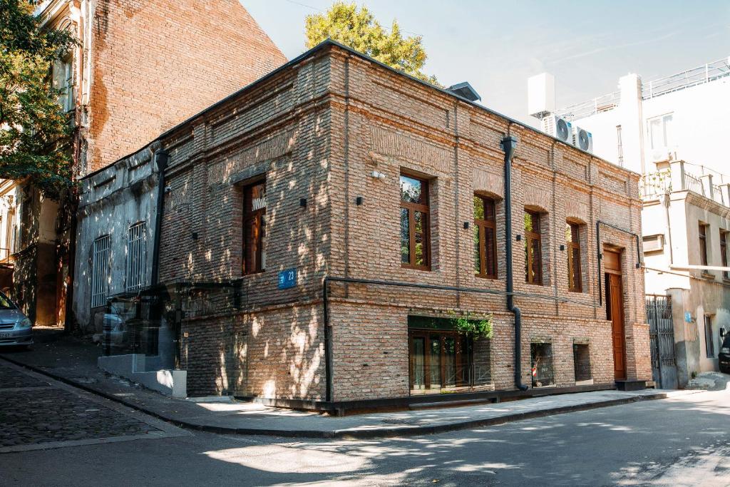 an old brick building on the side of a street at Urban Apartments 23 in Tbilisi City