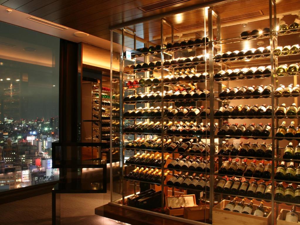 a room with a wall of wine bottles at Shinjuku Prince Hotel in Tokyo