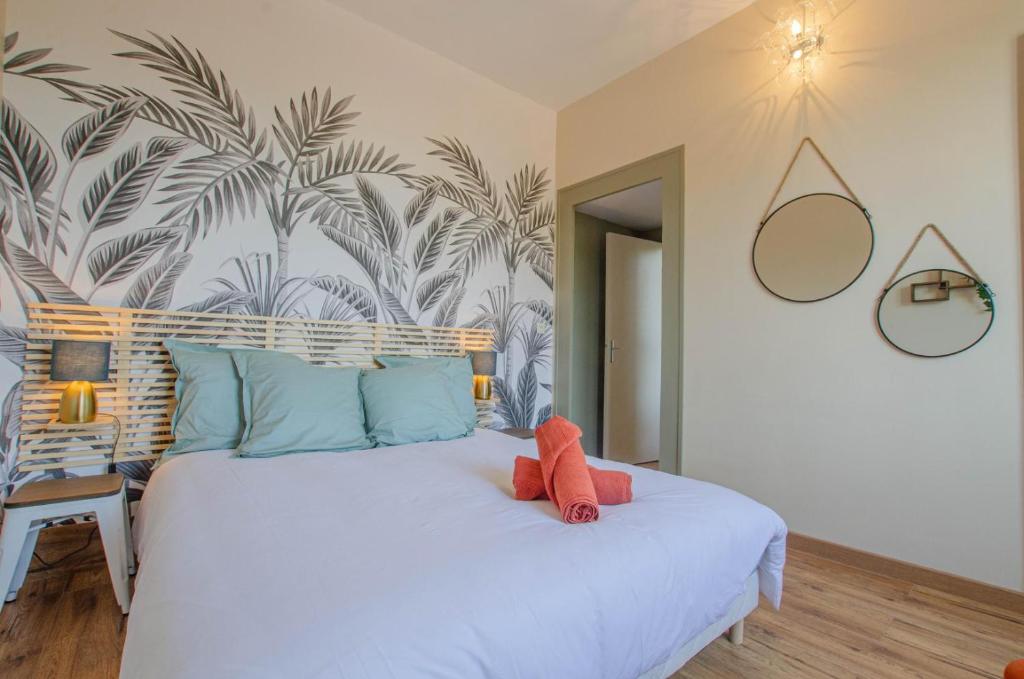 a bedroom with a large white bed with blue pillows at Hebergement 10G490 in Sainte-Savine