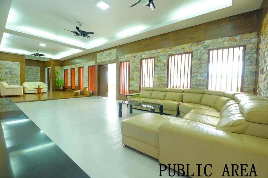 a living room with a couch and a table at Mersing Maple Villa in Mersing
