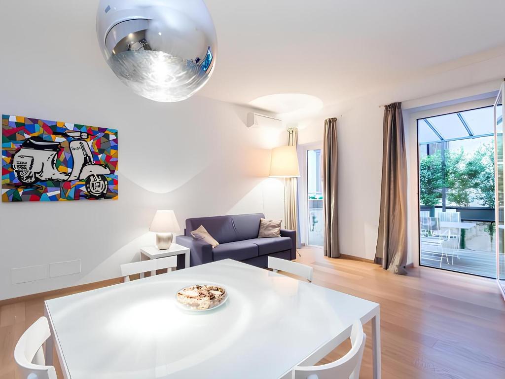 a living room with a white table and a couch at The Apartment at Spanish Steps in Rome
