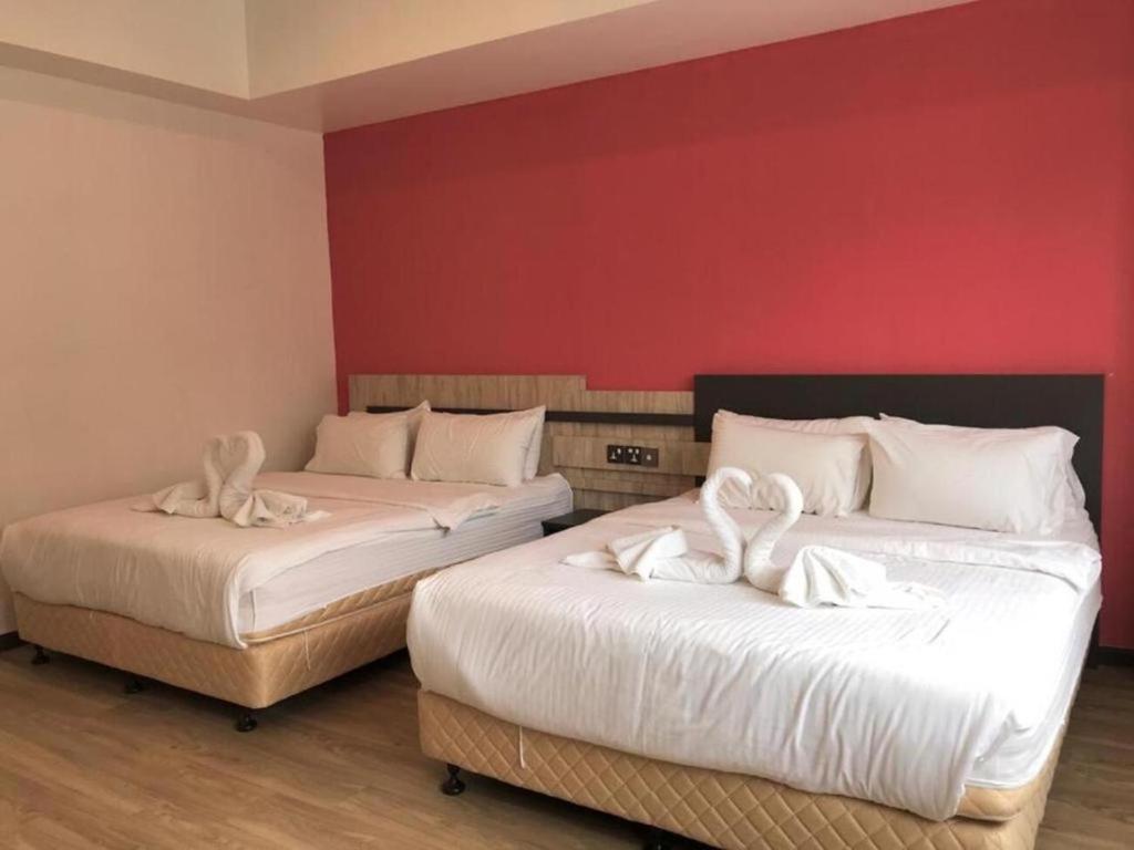 Postel nebo postele na pokoji v ubytování TT Dorf Hotel Taiping