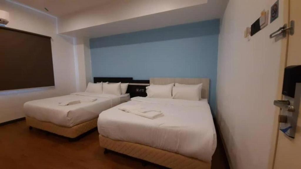 Postel nebo postele na pokoji v ubytování TT Dorf Hotel Taiping